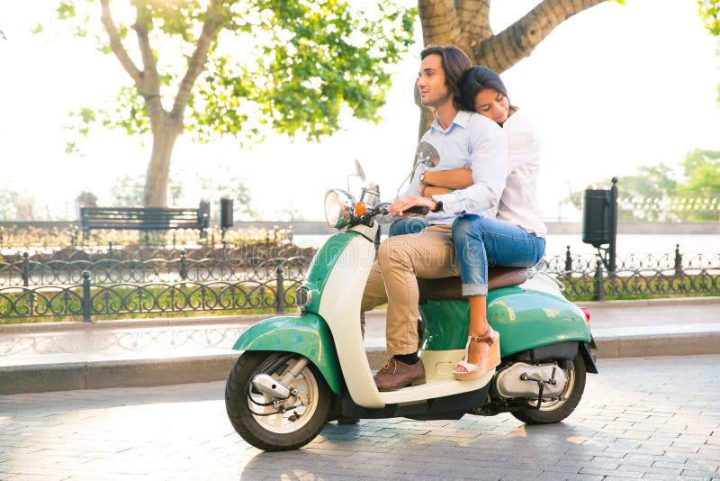 Happy Couple Riding on a Scooter Stock Photo - Image of smiling ...