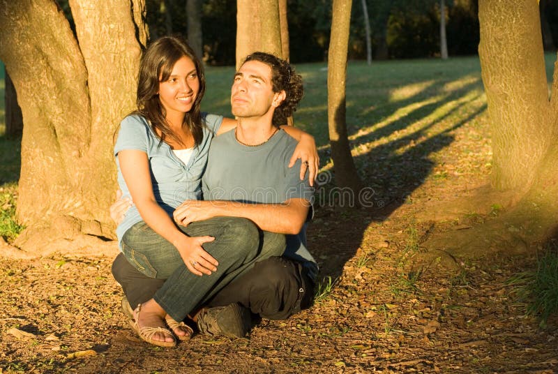 Happy Couple Sitting in the Woods. Horizontal