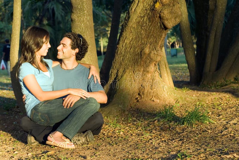 Happy Couple Sitting in the Woods. Horizontal