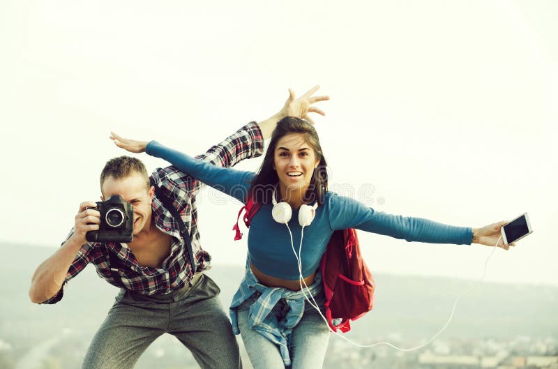 Happy couple smiling and pretend flying in sky stock photos Happy couple smiling and pretend flying in sky stock photos