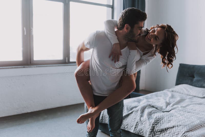 Happy Couple Together Having Fun in Bedroom Stock Photo