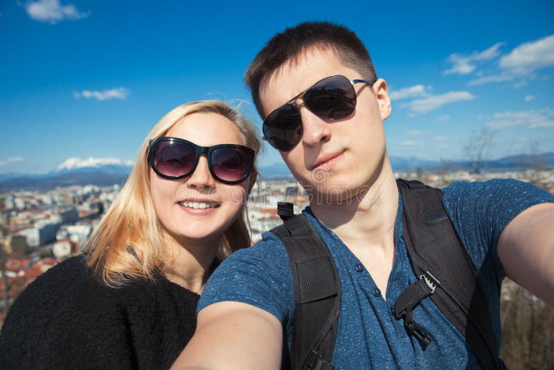 Happy couple traveling at the city and making selfie