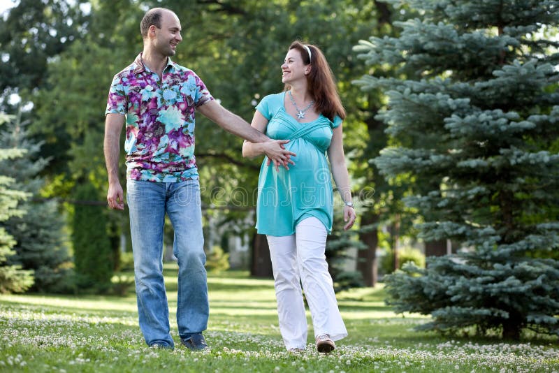 Happy couple walk in park