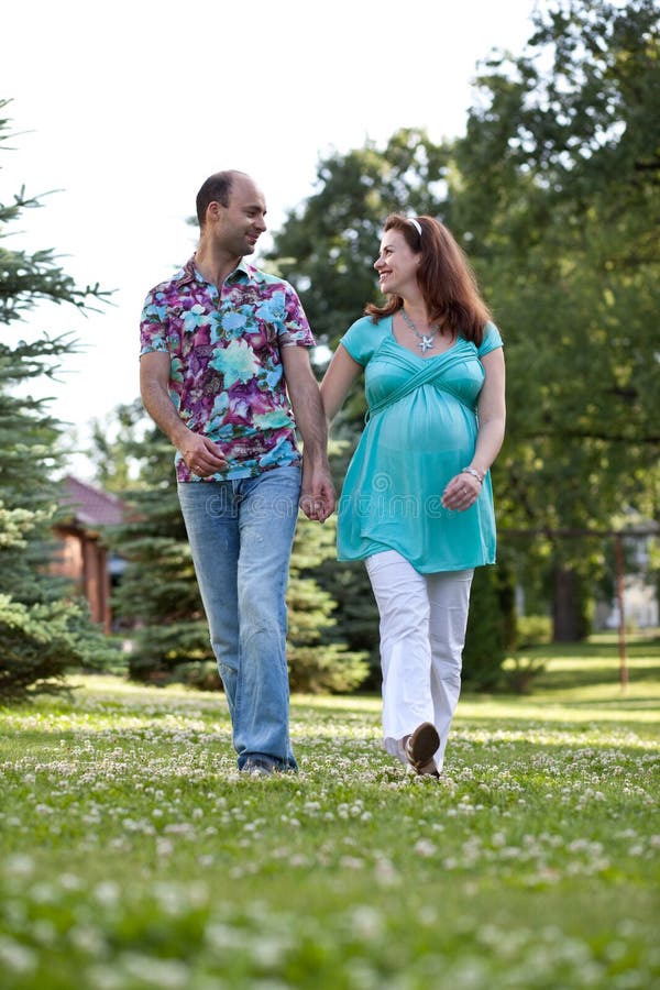 Happy couple walk in park