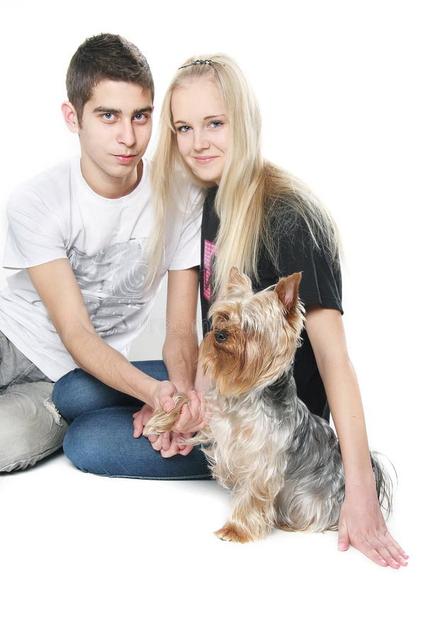 Happy couple with yorkshire terrier over white