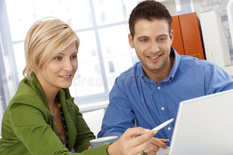 Happy coworkers working together stock photo