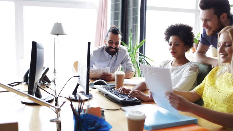 Happy creative team with computers in office stock video footage