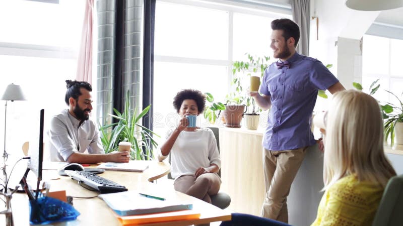 Happy creative team drinking coffee in office stock video