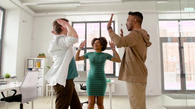Happy creative team making high five at office stock video footage