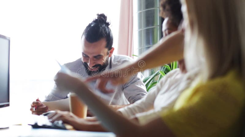 Happy creative team with papers talking in office stock footage