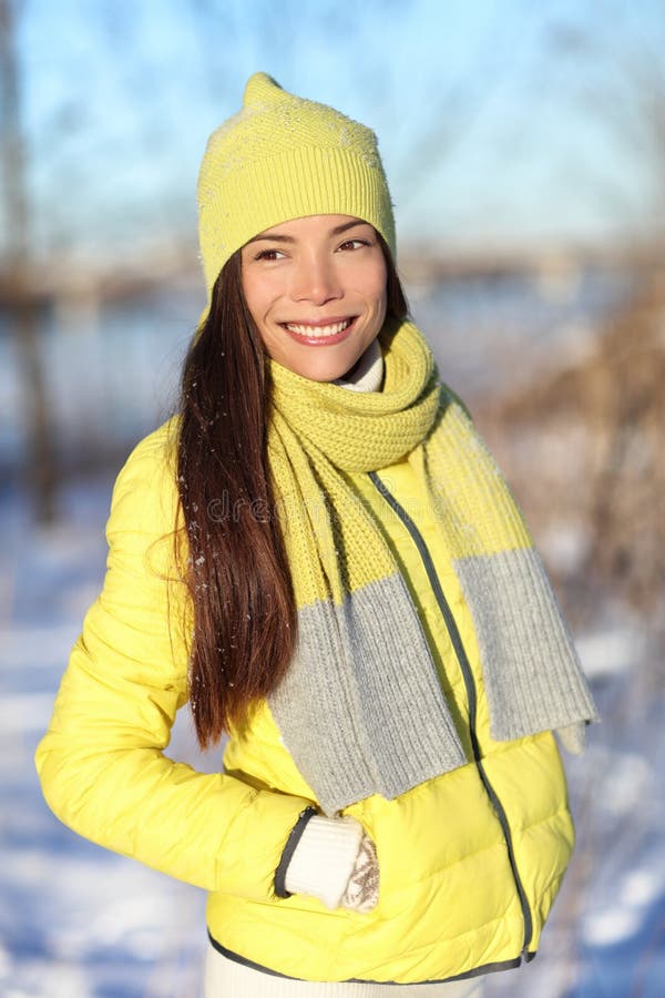 Happy cute Asian winter woman in snow