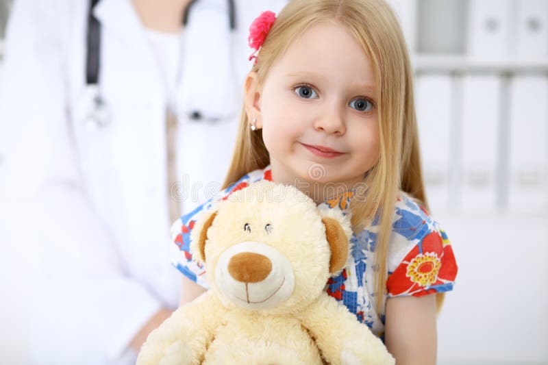 Happy cute baby after health exam at doctor`s office. Clinician, confident.