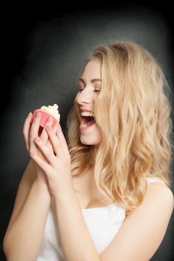 Happy cute woman eat sweet cake on black background royalty free stock photo Happy cute woman eat sweet cake on black background royalty free stock photo