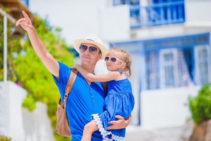 Family in Europe. Happy father and little adorable girl in Mykonos on summer greek vacation stock photography Family in Europe. Happy father and little adorable girl in Mykonos on summer greek vacation stock photography