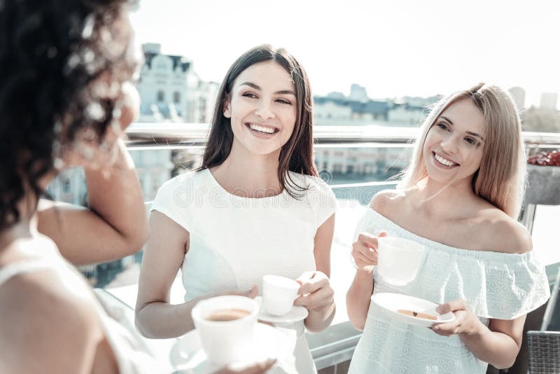 Happy delighted women listening to their friend royalty free stock image Happy delighted women listening to their friend royalty free stock image
