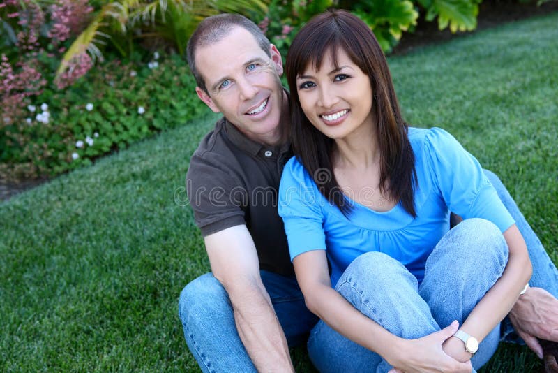 An attractive happy diverse couple in the park