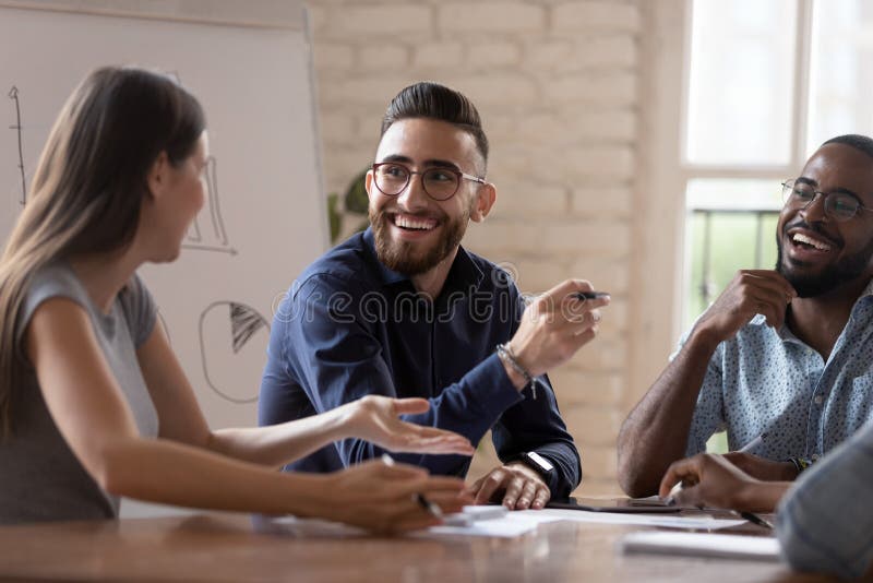 Happy diverse creative business team people talking at group meeting