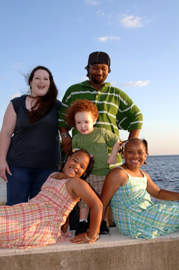 Happy diverse family at ocean