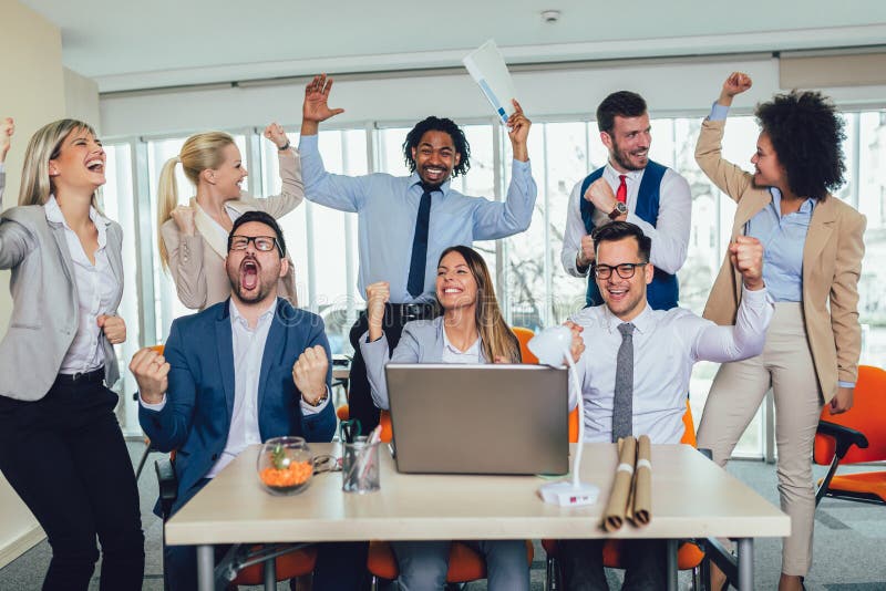 Happy diverse male and female business people in formal gathered around laptop computer