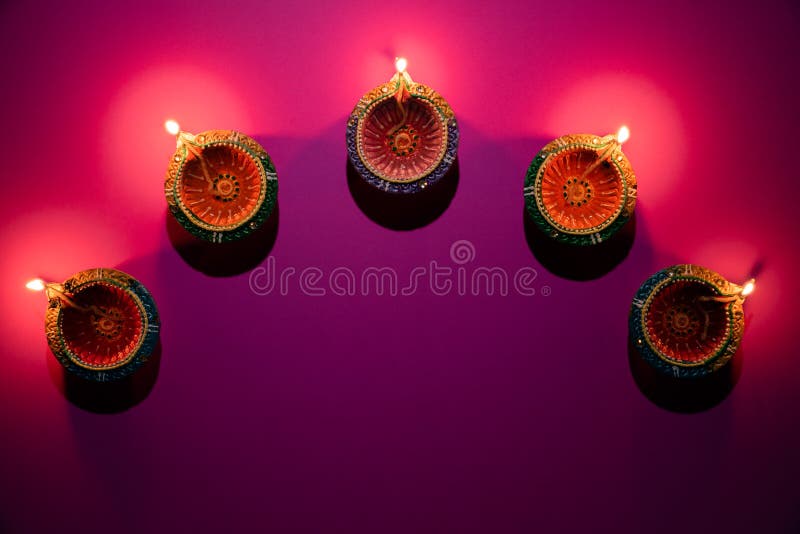 Happy Diwali - Clay Diya lamps lit during Dipavali, Hindu festival of lights celebration. Colorful traditional oil lamp diya on