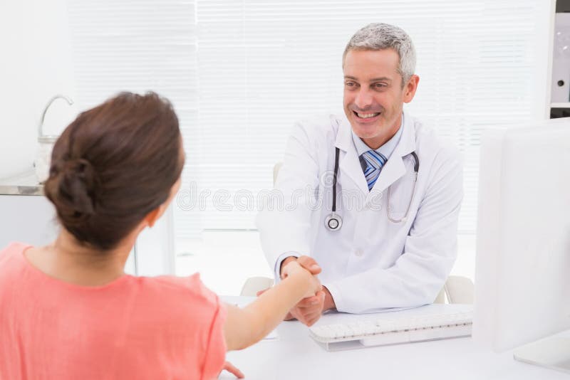 Happy doctor handshake at his patient royalty free stock images Happy doctor handshake at his patient royalty free stock images