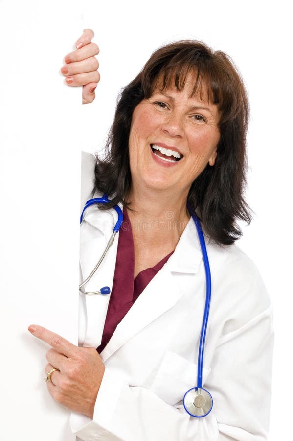 Vertical shot of a happy female doctor holding a blank sign and pointing...perfect for your copy for your business. Vertical shot of a happy female doctor holding a blank sign and pointing...perfect for your copy for your business