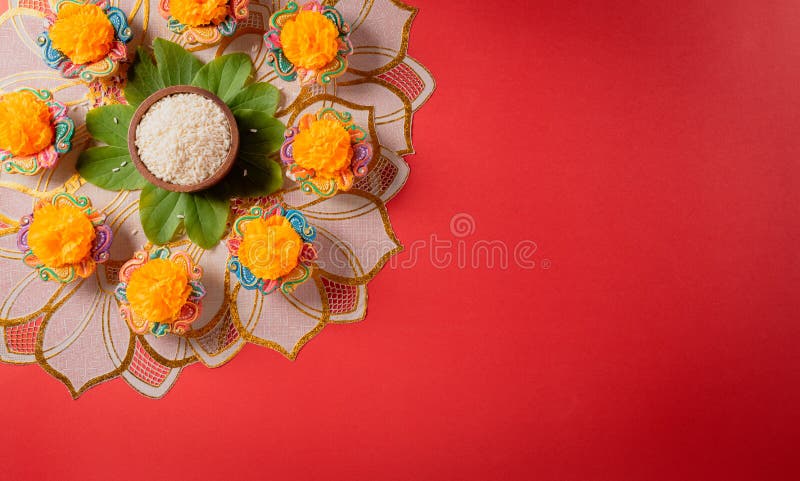Happy Dussehra. Yellow flowers, green leaf and rice on red background. Dussehra Indian Festival concept stock photography