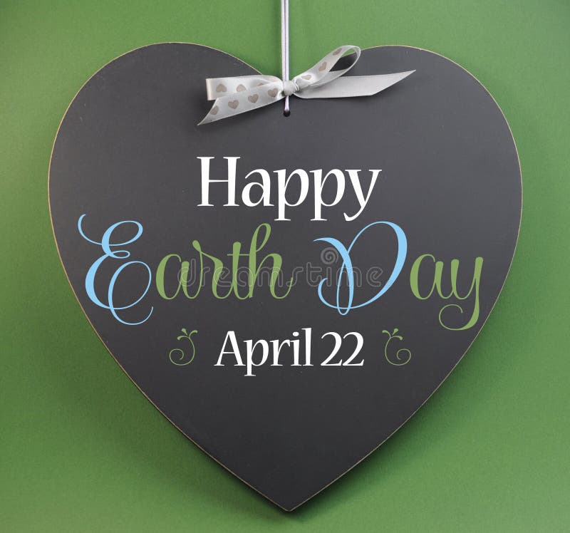 Happy Earth Day April 22, message sign greeting on a heart shaped blackboard