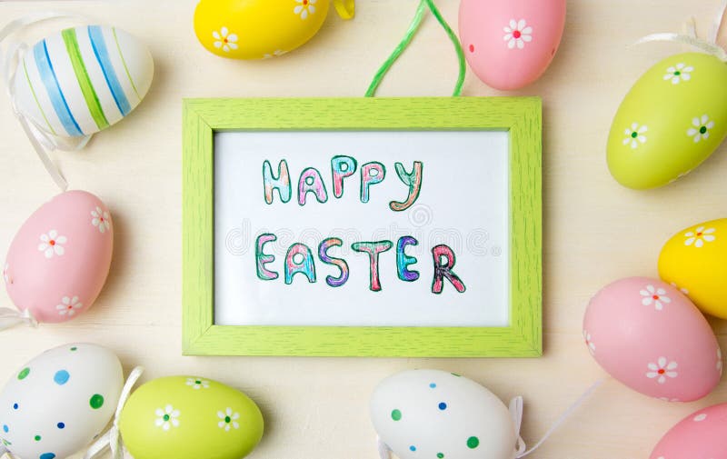 Happy Easter card in a frame with colorful eggs stock photos Happy Easter card in a frame with colorful eggs stock photos