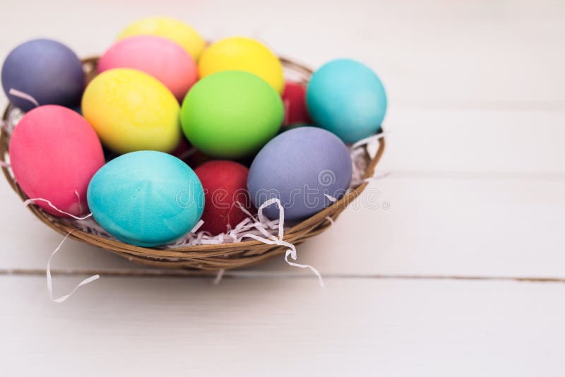 Happy Easter with Colorful Pastel Easter Eggs on Wooden Background