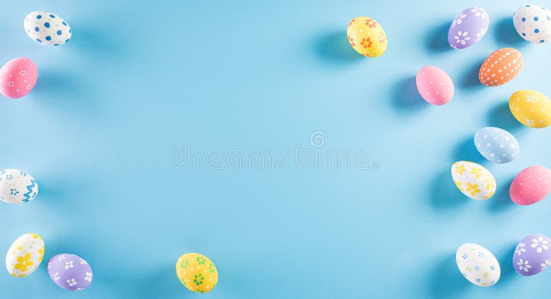 Happy easter! Colourful of Easter eggs on pastel blue background. Greetings and presents for Easter Day celebrate time. Flat lay