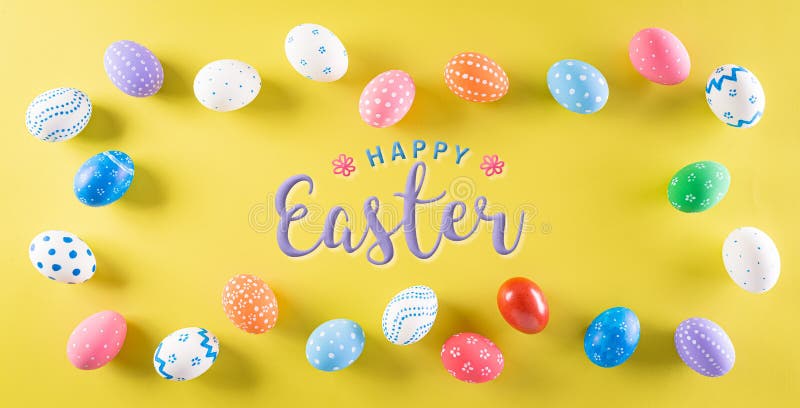 Happy easter! Colourful of Easter eggs on pastel yellow background. Top view with Happy Easter text