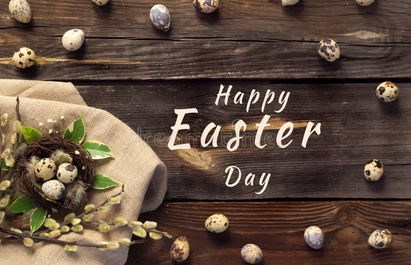 Happy Easter greeting card.Small eggs in a nest with willow branches on a rustic wooden background.Banner with holiday royalty free stock images Happy Easter greeting card.Small eggs in a nest with willow branches on a rustic wooden background.Banner with holiday royalty free stock images