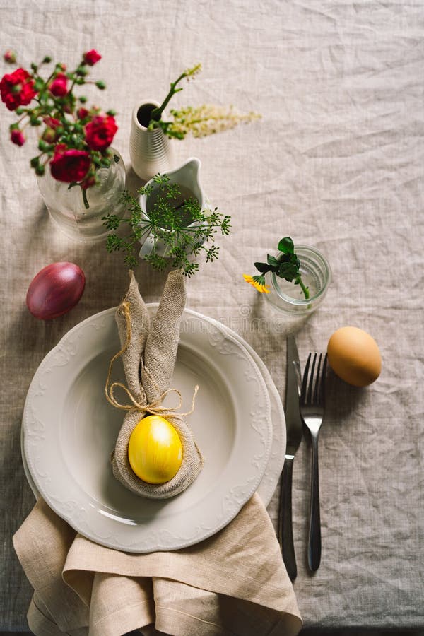 Happy Easter. Stylish Easter Eggs on a Napkin with Spring Flowers on
