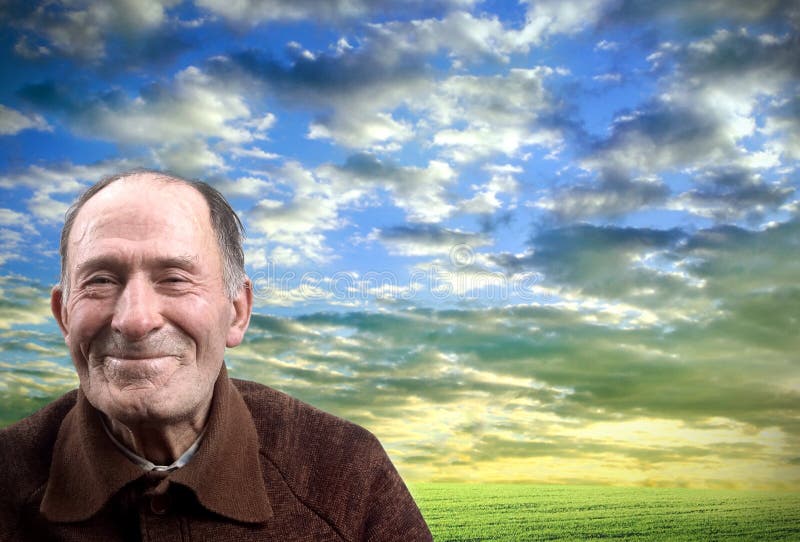 The happy elderly man against the sunset sky