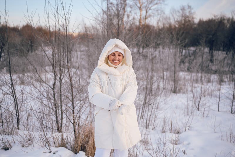 Happy Elderly Senior Mature Woman in White Warm Outwear Playing with ...