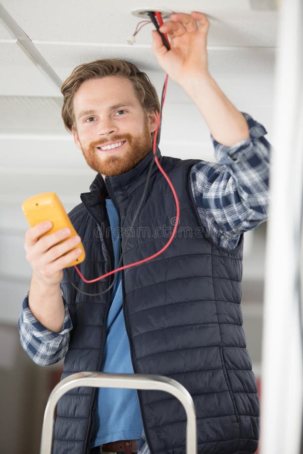 Happy Electrician Measuring Voltage in House Stock Photo Image of device, work 269561674