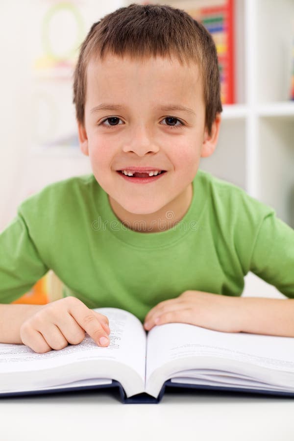 Happy elementary school boy practice reading