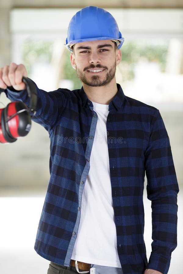 Happy engineer builder giving earphones royalty free stock images