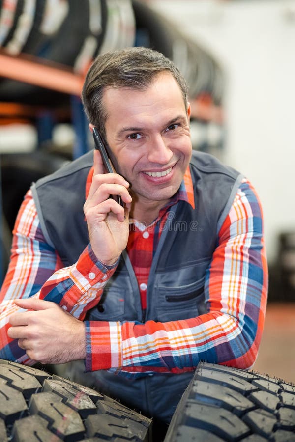 Happy engineer in phone working in workshop royalty free stock photos