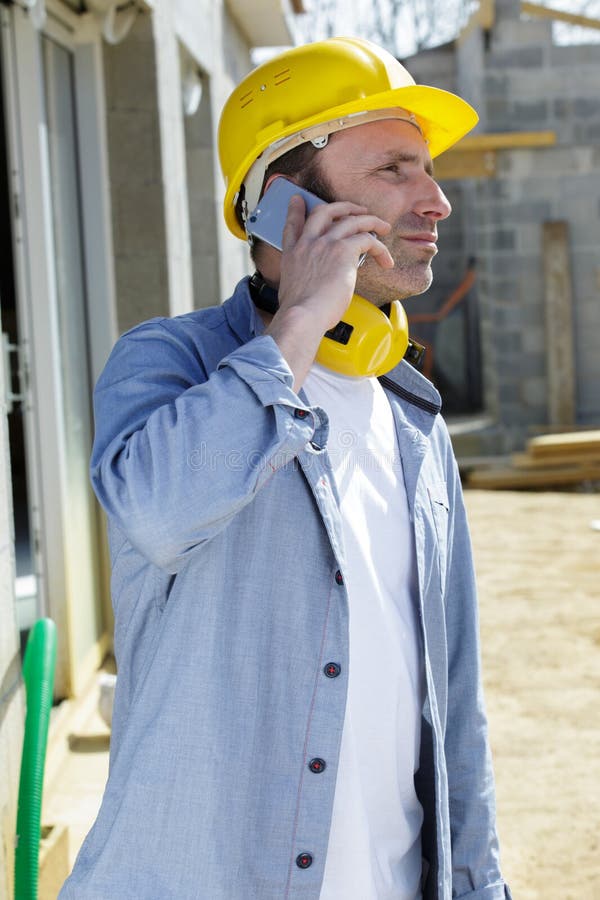 Happy engineer talking to clients royalty free stock photo