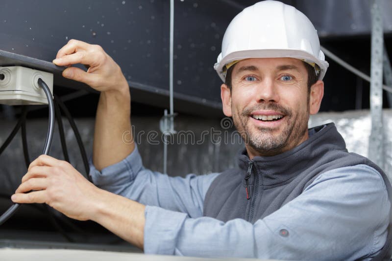 Happy engineer tests power high voltage royalty free stock photo