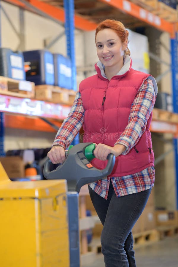 Happy engineer wearing while leaning on steering in workshop stock photo