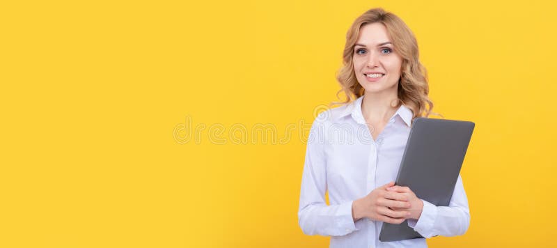 happy entrepreneur lady in white shirt hold laptop on yellow background, business. Woman isolated face portrait, banner stock photography