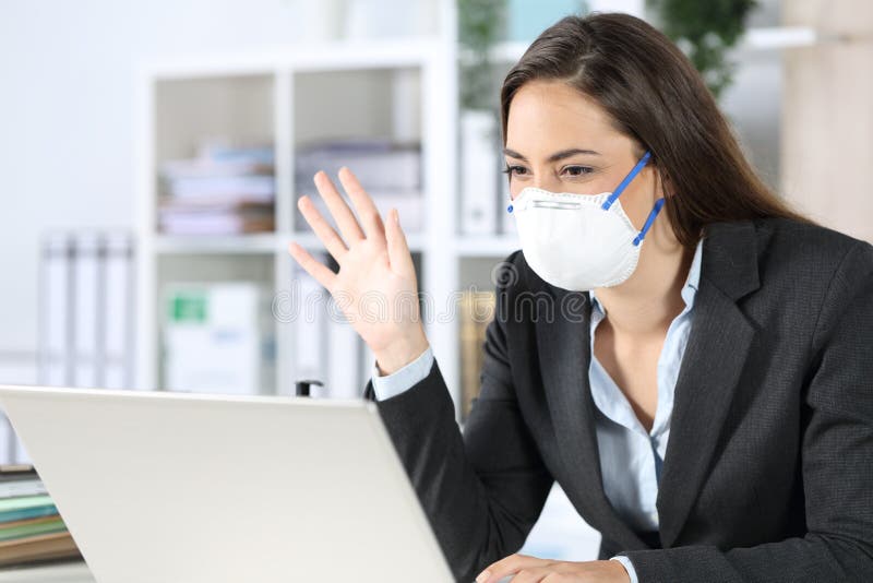 Happy executive on videocall greeting avoiding covid-19 at office royalty free stock photos Happy executive on videocall greeting avoiding covid-19 at office royalty free stock photos