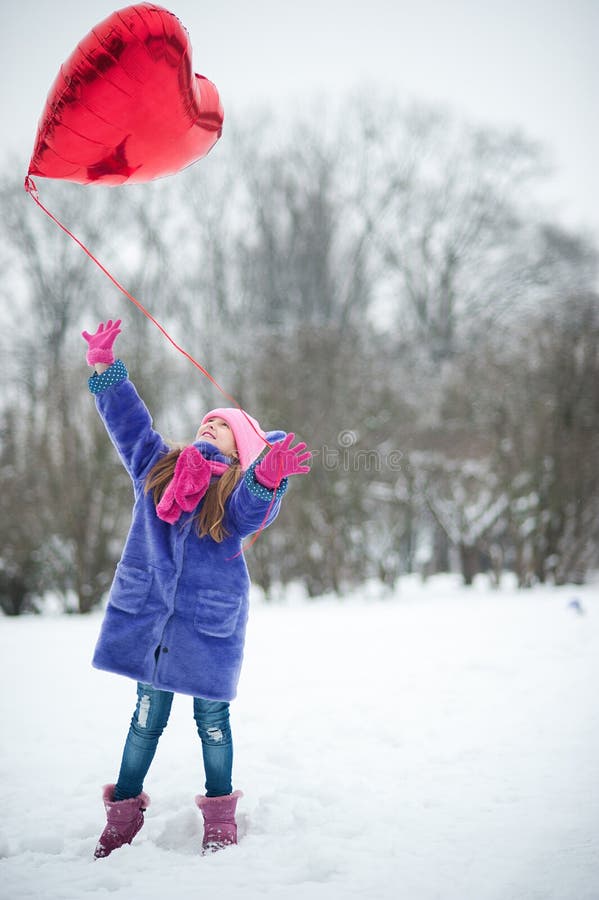Happy exited girl with Valentine heart balloons outdoor. Valentine`s day concept. Copy space. stock image Happy exited girl with Valentine heart balloons outdoor. Valentine`s day concept. Copy space. stock image