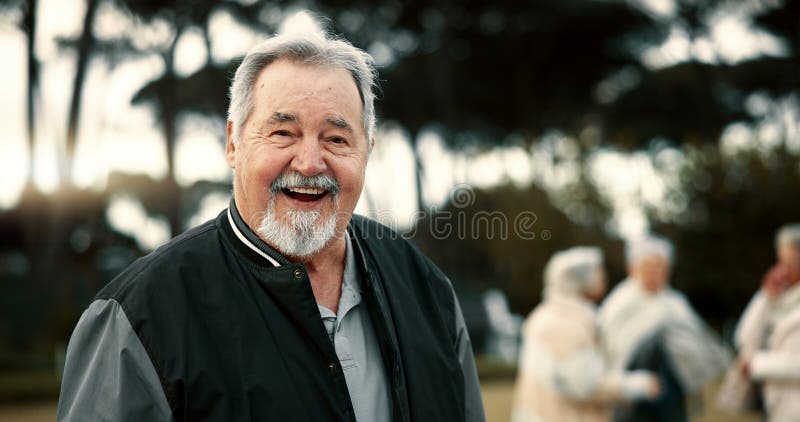 Happy, face and a senior man in nature for retirement games, fun and relax with friends. Laughing, summer and portrait