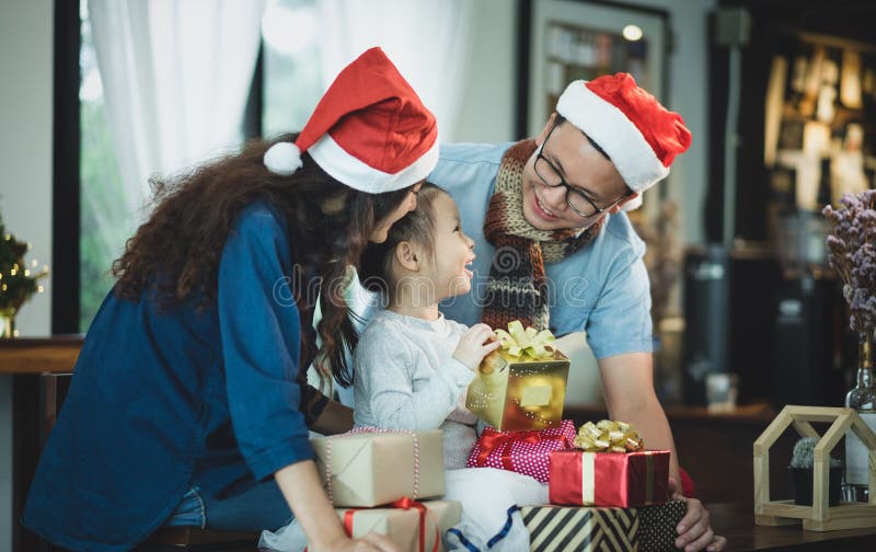 Happy family Asia family wear santa claus hat unwrap Christmas g royalty free stock images Happy family Asia family wear santa claus hat unwrap Christmas g royalty free stock images