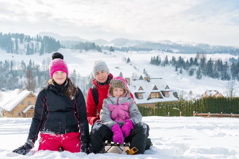 happy family on the background of a winter mountain landscape - mom and daughters on a snowy hillside in Pieniny mountains stock images happy family on the background of a winter mountain landscape - mom and daughters on a snowy hillside in Pieniny mountains stock images