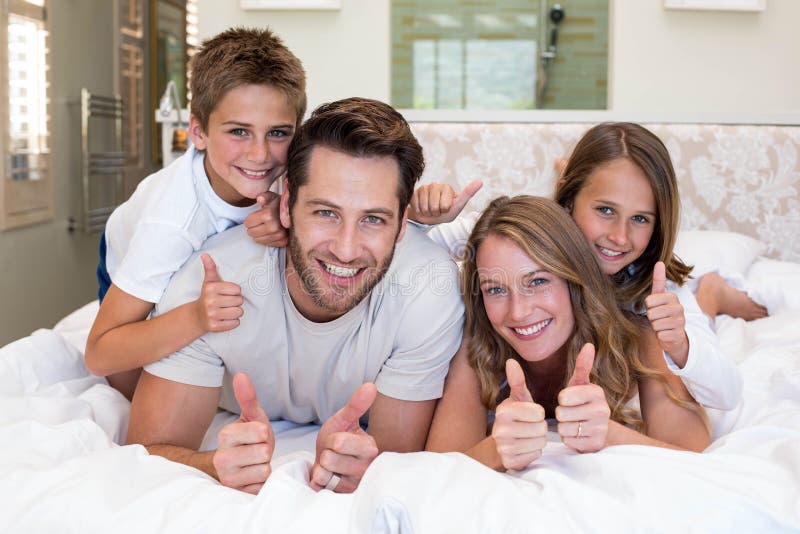 Happy family on the bed royalty free stock photos
